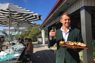 Paul West with grilled bugs at the Sandstone Point Hotel oyster shed. Here's cheers to the upcoming Regional Flavours.