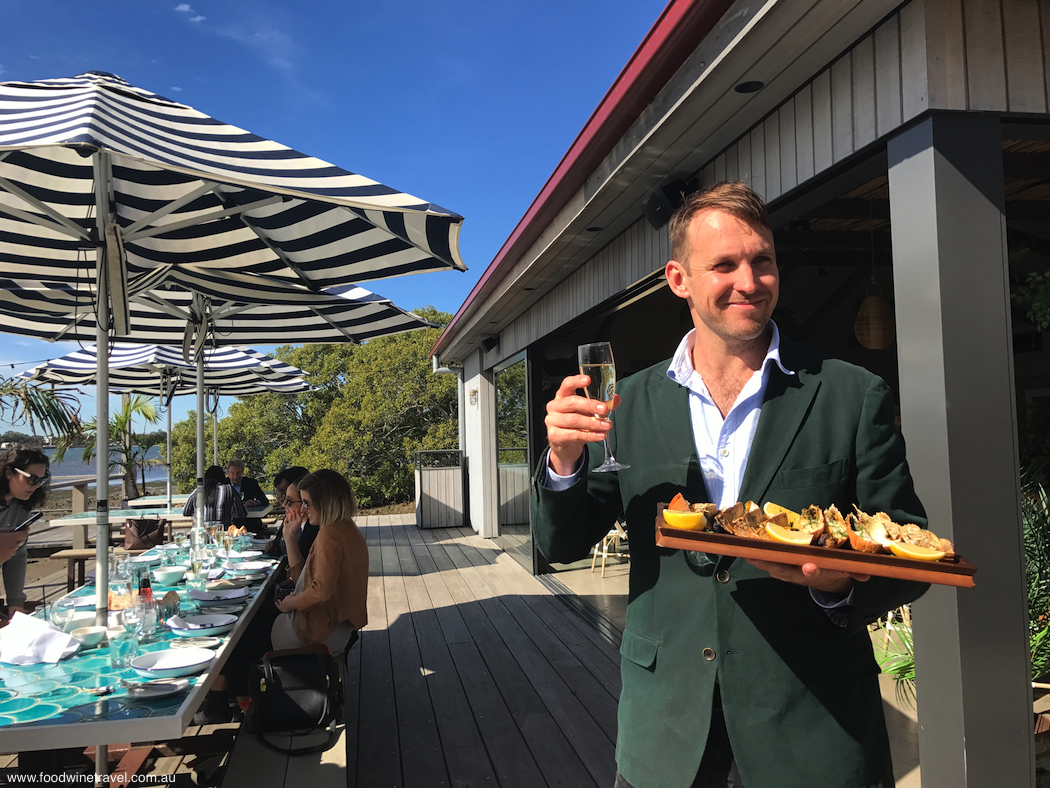 Paul West with grilled bugs at the Sandstone Point Hotel oyster shed. Here's cheers to the upcoming Regional Flavours.