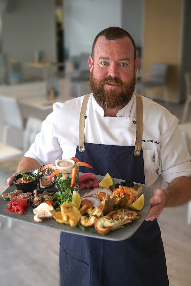 The Sebel Margate Chef holding seafood platter