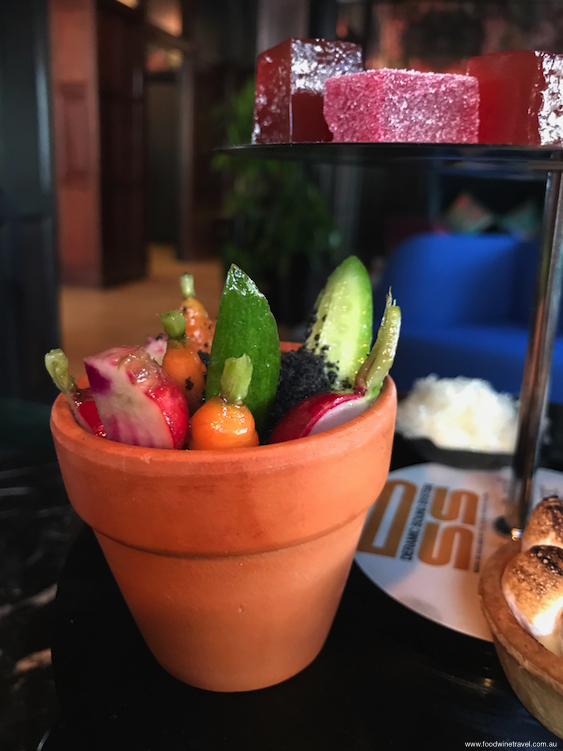 The Edible Garden filled with dainty little carrots, radishes and cucumber pushed into a bed of dip sprinkled with "soil". 