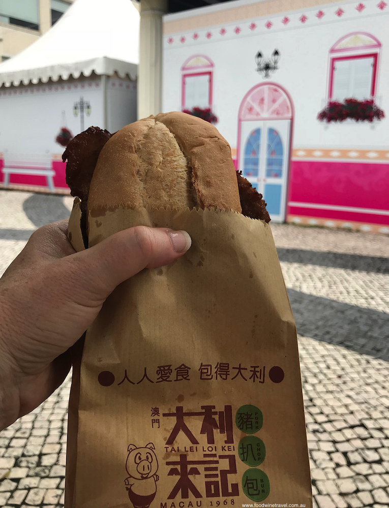 Charcoal-grilled pork sandwiched between a crisply baked baguette, enjoyed in Taipa.