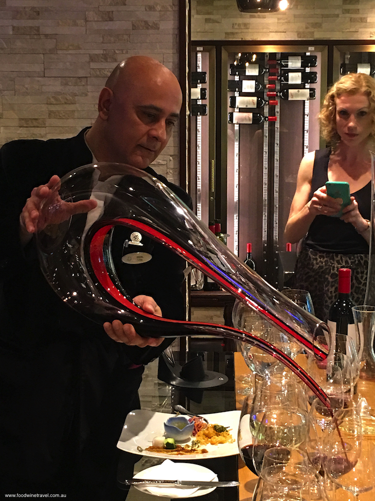 Genting Dream's Cellar Master Erdal Uysal pours from a mighty decanter.