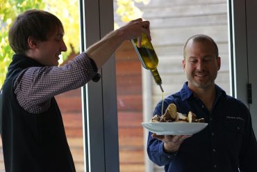 Primo Estate’s Matteo Grilli pouring oil for cellar door manager, Mark Van Gestel, at the Estate’s 2018 olive harvest celebration.