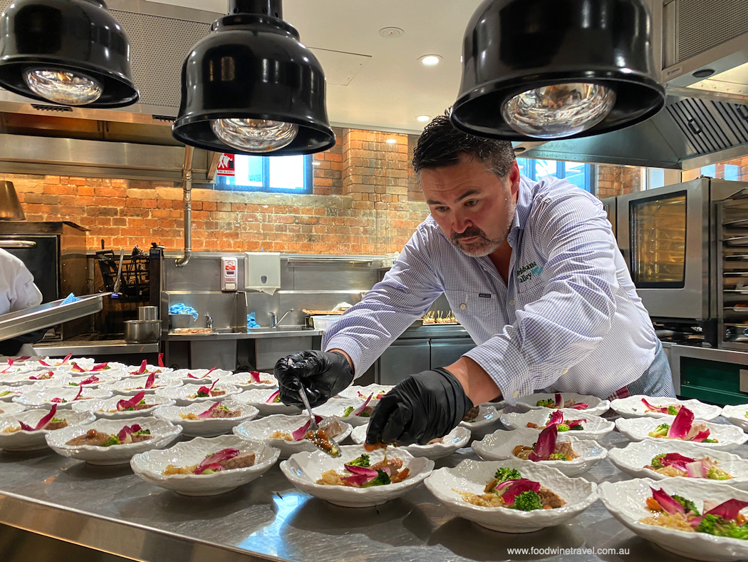 Consultant chef Jason Peppler puts the finishing touches to Cold-smoked Quail Breast Salad.