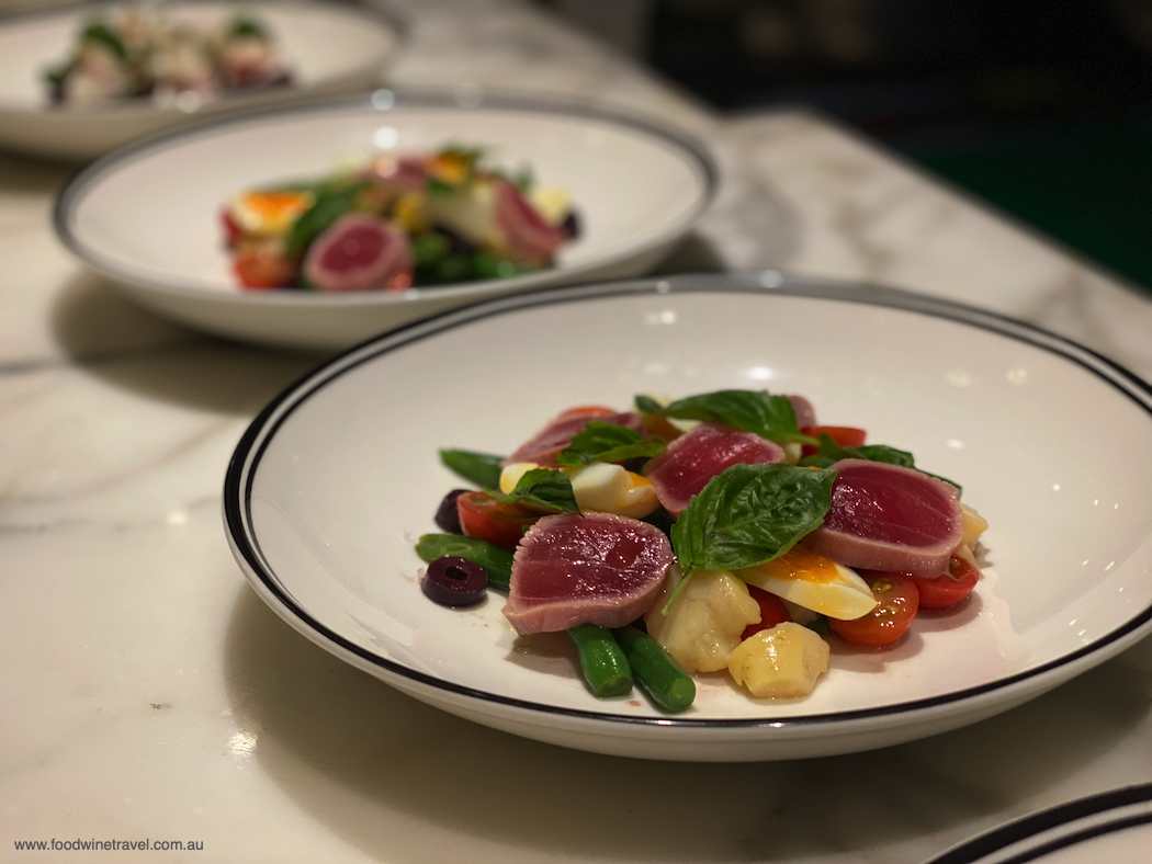 Starter of tuna with green beans, potato, tomato and olives.