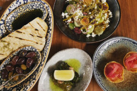 The meze at Ploós includes sourdough pita, exquisite dolmades, kataifi tarts filled with pastourma and candied eggplant, and the chef's take on nissiotiki salad.