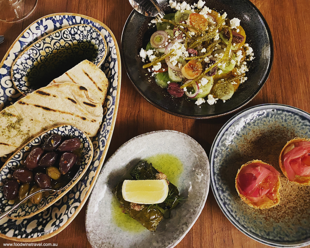 The meze at Ploós includes sourdough pita, exquisite dolmades, kataifi tarts filled with pastourma and candied eggplant, and the chef's take on nissiotiki salad.