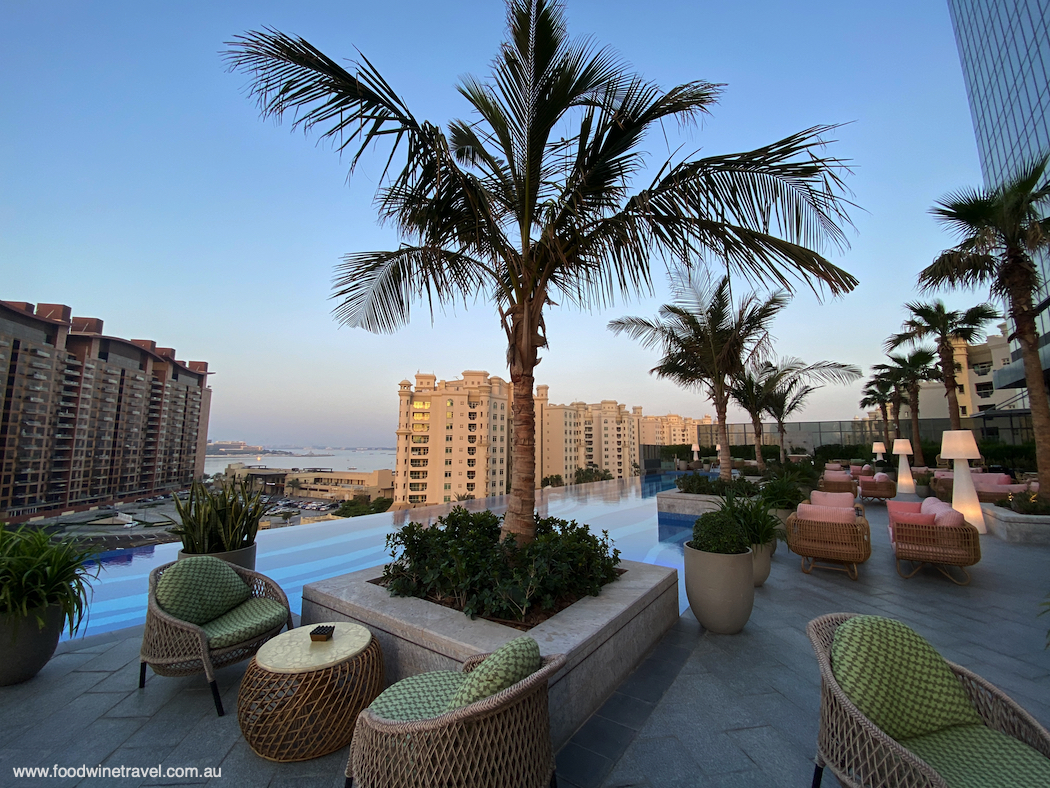 The outdoor lounge and infinity pool at The St. Regis Dubai, The Palm.