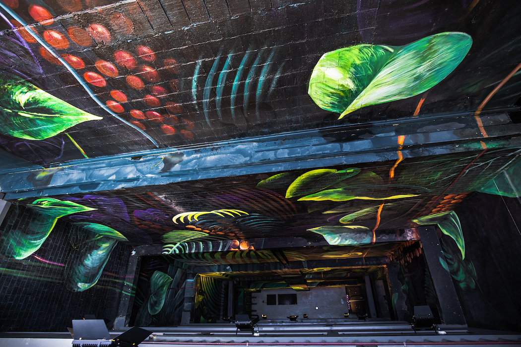 Jessica Le Clerc's 25-metre-high wall mural depicts lush rainforest greenery.