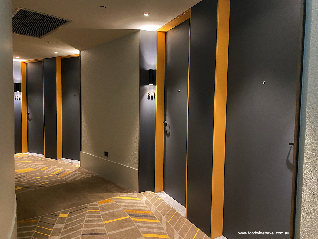 The yellow and charcoal colour theme extends to the hallways (on a curve owing to the building's round shape).