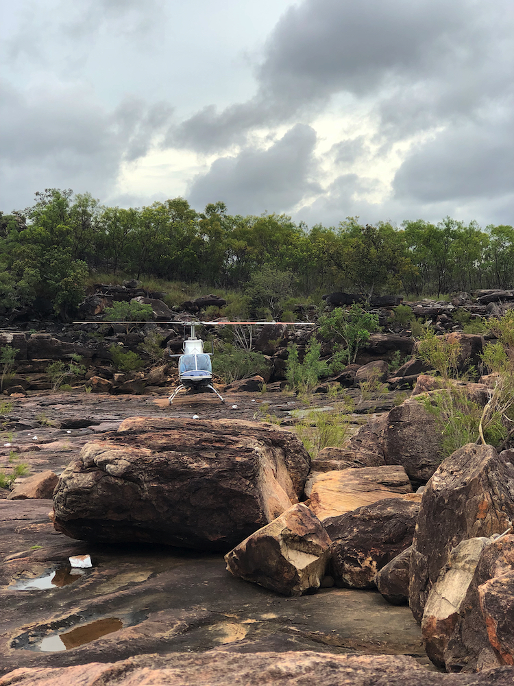 The helicopter flight over Mitchell Falls lands on a rocky platform near the falls.