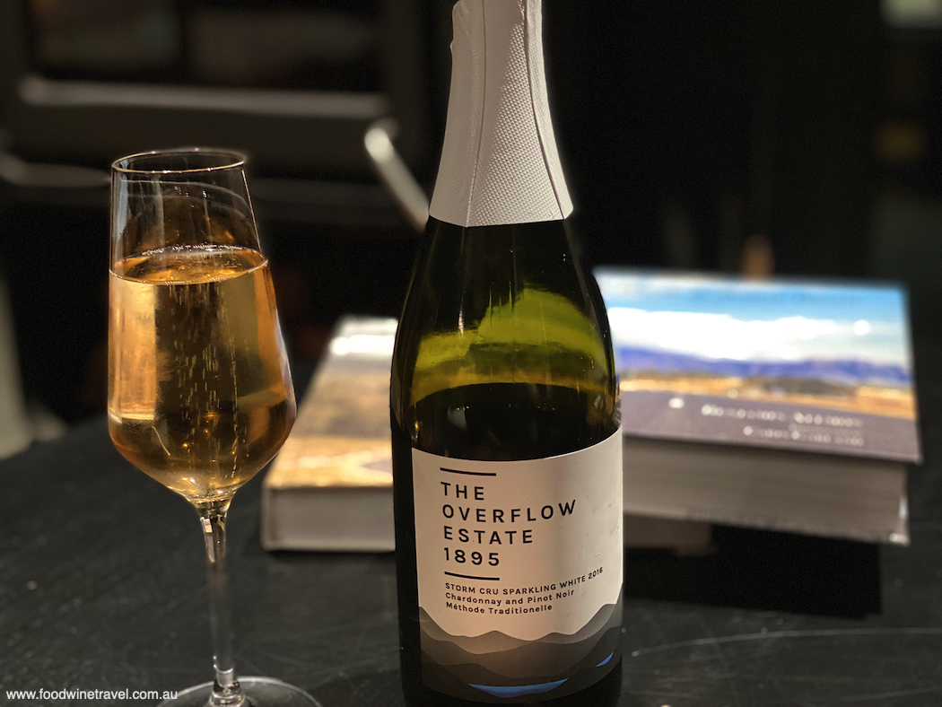 We settle in with a bottle of The Overflow Estate 1895 Storm Cru Sparkling White.