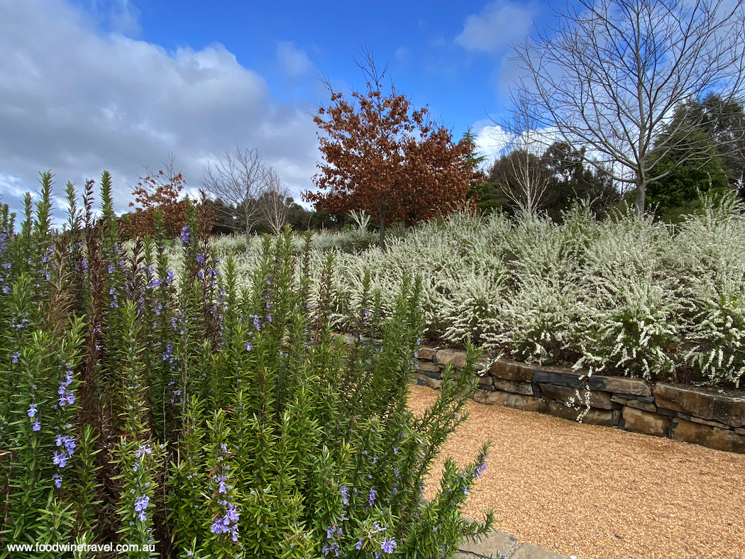 Masses of plantings welcome visitors at the garden entry.
