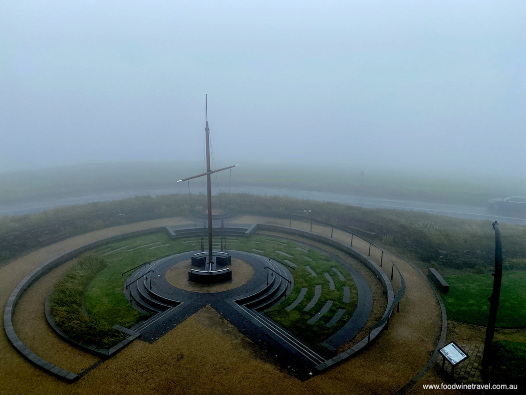 The view of the Lusitania memorial from the Old Head Signal Tower is almost obscured by the lousy weather - but no matter, the weather at least gives you something to talk about.