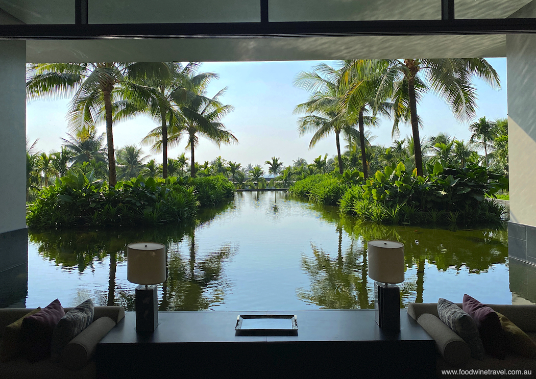 Windows in the lobby frame a view of lush tropical gardens and koi-filled lagoons.