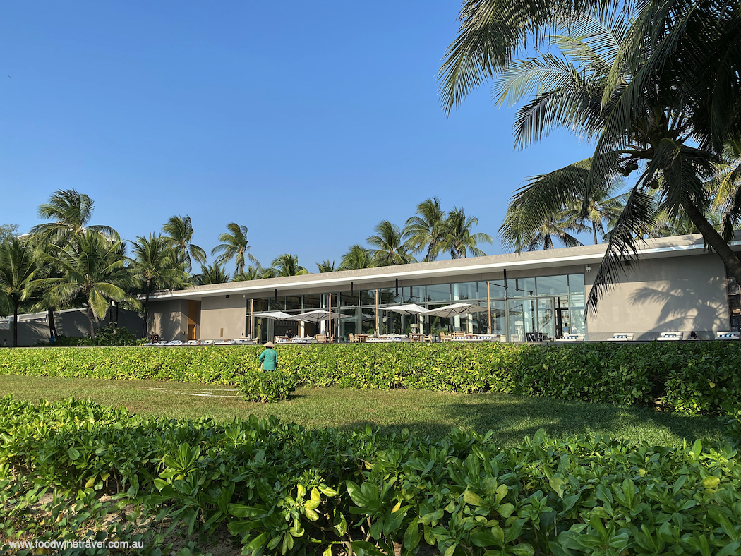 A gardener tends the gardens in front of Ocean Club restaurant.