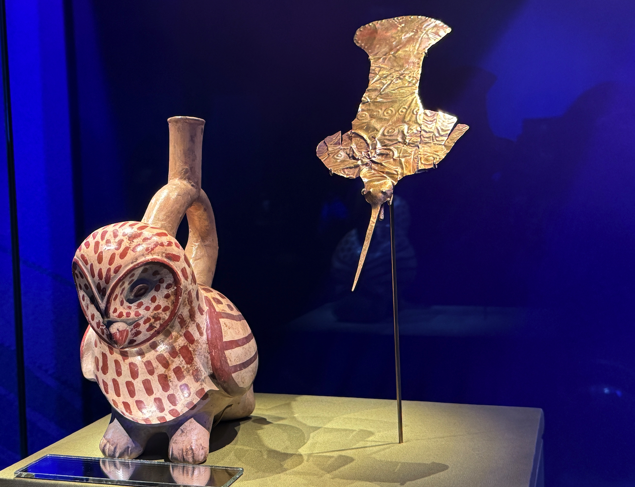 Ceramic owl bottle (100CE-800CE) and gold hummingbird pin (100CE-600CE).