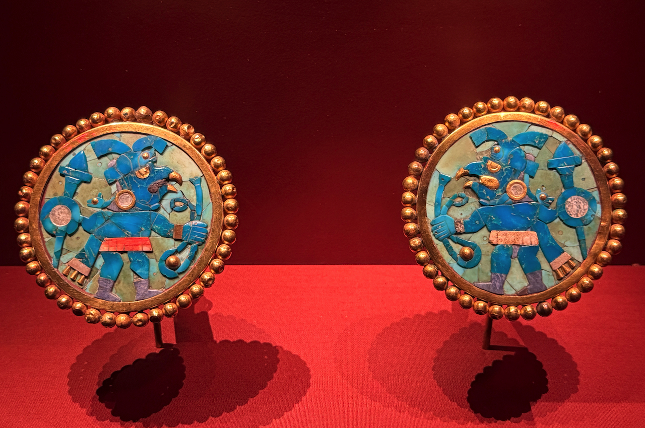 Gold, turquoise, mother of pearl, and spondylus shell ear flares with mosaic bird-warrior (100CE-800CE).
