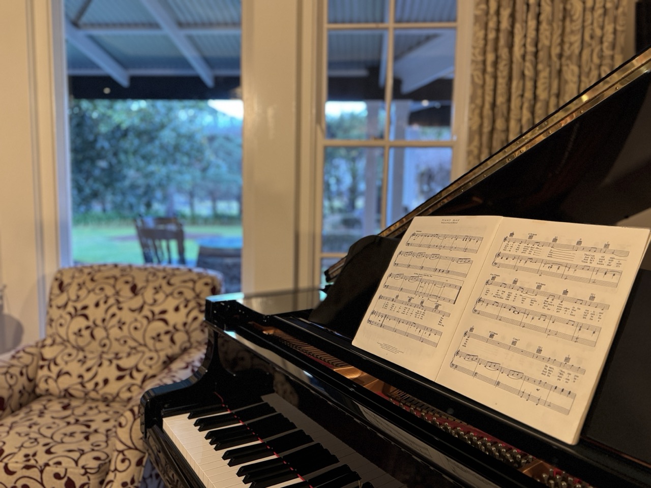 A grand piano in the Homestead reflects the owners’ love of music.