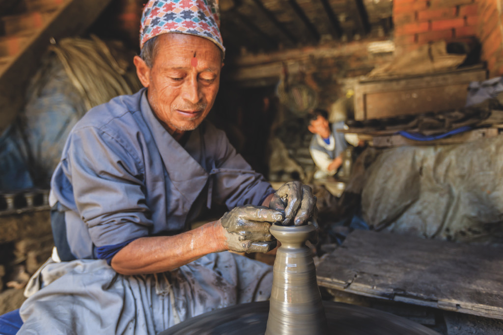 Nepalese potter working in his workshop in Bhaktapur. Photo by Bartosz Hadyniak / Getty Images.