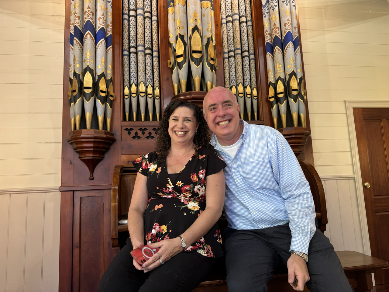 Thomas and Simone Heywood in front of the magnificent 1875 pipe organ they installed in the chapel at Langley Estate.