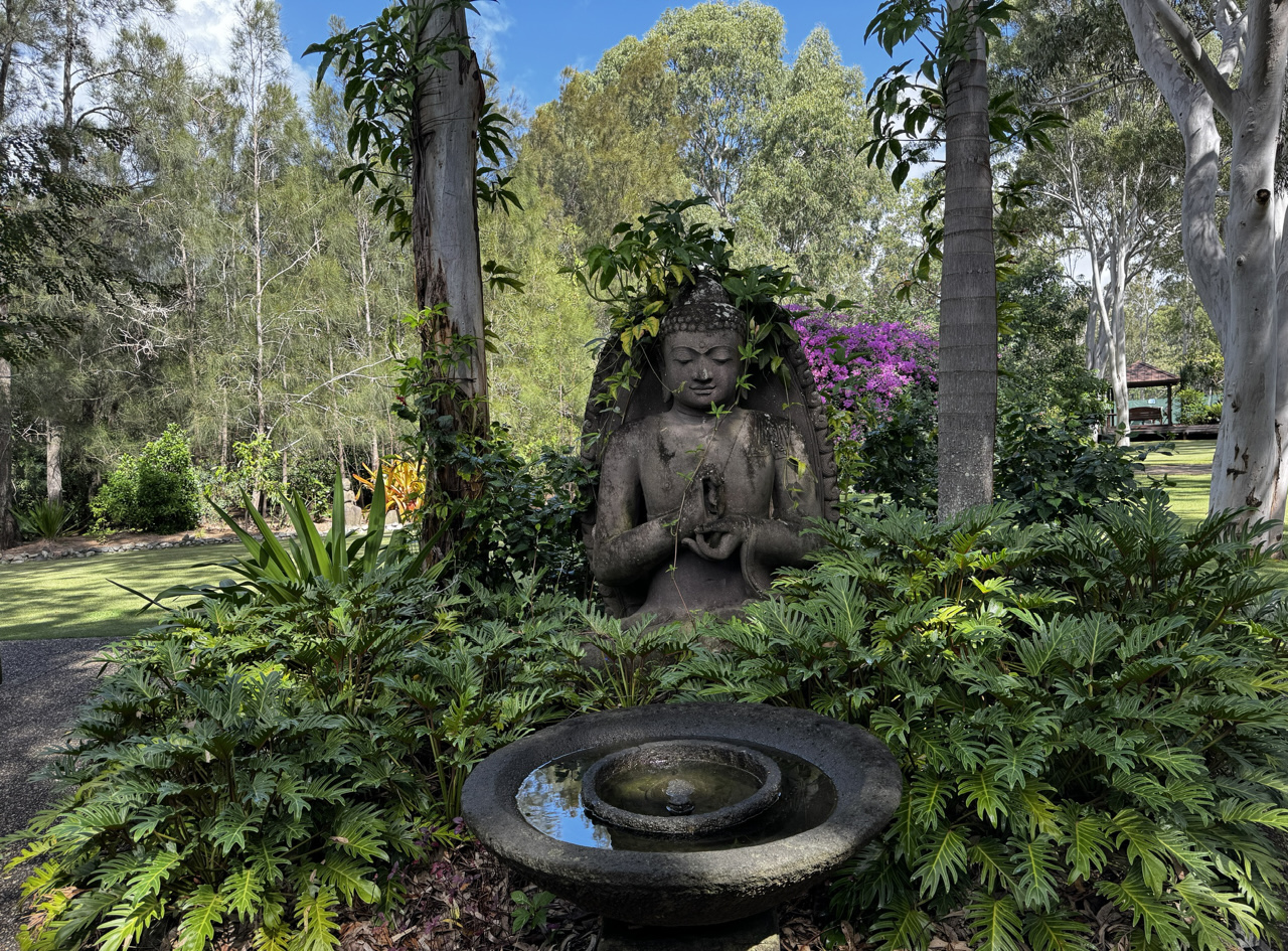 The grounds are beautifully landscaped with lush vegetation.